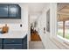 View from the kitchen into the hallway, showcasing hardwood floors, natural light, and open layout at 117 S Pierce St, Lakewood, CO 80226