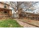 Large tree provides shade in a yard with access to a storage shed at 17882 E Wyoming Pl, Aurora, CO 80017