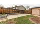 Backyard view with concrete slab and wooden fence at 17882 E Wyoming Pl, Aurora, CO 80017