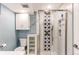 Updated bathroom with a glass enclosed shower, tile details, and white fixtures at 17882 E Wyoming Pl, Aurora, CO 80017