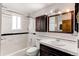 Bathroom featuring a shower-tub combination, vanity, and tiled countertop at 17882 E Wyoming Pl, Aurora, CO 80017