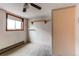 Compact carpeted bedroom with window, built in shelves, ceiling fan and radiator at 17882 E Wyoming Pl, Aurora, CO 80017