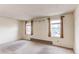 Bedroom featuring natural light from two windows with tan drapes and an electric baseboard heater at 17882 E Wyoming Pl, Aurora, CO 80017