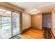 Bright dining area with wood floors, patio access, and neutral wall color at 17882 E Wyoming Pl, Aurora, CO 80017