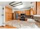 Spacious kitchen featuring a breakfast bar, stainless steel appliances, and custom cabinets at 17882 E Wyoming Pl, Aurora, CO 80017