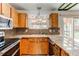 Cozy kitchen showcasing granite countertops, mosaic backsplash, and wood cabinetry at 17882 E Wyoming Pl, Aurora, CO 80017