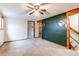 Spacious living room with neutral carpet, ceiling fan, and access to stairs at 17882 E Wyoming Pl, Aurora, CO 80017