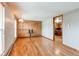 Inviting living room featuring wood floors, paneled accent wall, and neutral decor at 17882 E Wyoming Pl, Aurora, CO 80017