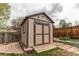 Exterior view of a shed with double doors and decorative details at 17882 E Wyoming Pl, Aurora, CO 80017