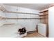 Functional storage room with ample shelving, workbench, and white walls at 17882 E Wyoming Pl, Aurora, CO 80017