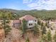 Aerial view of the home showing the roof and surrounding mountain landscape at 3191 Bittersweet Ln, Evergreen, CO 80439