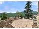 Stone patio with fire pit overlooks the surrounding mountain views at 3191 Bittersweet Ln, Evergreen, CO 80439