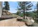 Outdoor patio area with stone pavers and fire pit with mountain views at 3191 Bittersweet Ln, Evergreen, CO 80439