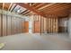 Spacious basement with exposed wooden framing and carpeted floor at 3191 Bittersweet Ln, Evergreen, CO 80439