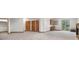 Spacious basement area with carpet flooring, doors and access to the exterior at 3191 Bittersweet Ln, Evergreen, CO 80439