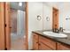 Bright bathroom featuring a vanity with black fixtures, a tub, and a shower with a curtain at 3191 Bittersweet Ln, Evergreen, CO 80439