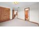 Spacious carpeted bedroom with wood trim and doors, offering ample space and hallway access at 3191 Bittersweet Ln, Evergreen, CO 80439
