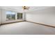 A spacious bedroom with natural light and a ceiling fan at 3191 Bittersweet Ln, Evergreen, CO 80439