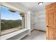 A window seat and built-in shelving enhance this carpeted walk-in closet, offering storage and mountain views at 3191 Bittersweet Ln, Evergreen, CO 80439