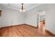 Charming dining room boasts hardwood floors, a stylish light fixture, and seamless flow to the kitchen at 3191 Bittersweet Ln, Evergreen, CO 80439