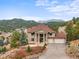 Stunning two-story home with mountain views, a well-manicured lawn, and a convenient three-car garage at 3191 Bittersweet Ln, Evergreen, CO 80439