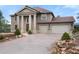 Beautifully landscaped home with a spacious three-car garage and manicured greenery at 3191 Bittersweet Ln, Evergreen, CO 80439