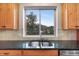 Well-lit kitchen sink and counter with view out to the neighborhood and mountains at 3191 Bittersweet Ln, Evergreen, CO 80439