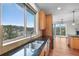 Bright kitchen with mountain views from the sink window and access to the outdoor balcony at 3191 Bittersweet Ln, Evergreen, CO 80439