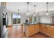 Open-concept living space features wood floors, a stone fireplace, and a walkout balcony with mountain views at 3191 Bittersweet Ln, Evergreen, CO 80439