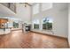 Bright living room boasts soaring ceilings, large windows with mountain views, and a stone fireplace at 3191 Bittersweet Ln, Evergreen, CO 80439
