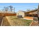 Serene backyard with a hot tub, a covered patio with a deck, and grassy area at 1801 S Meade St, Denver, CO 80219
