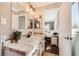 Updated bathroom with tiled countertops, a stylish sink, and an open doorway to the bedroom at 1801 S Meade St, Denver, CO 80219