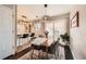 Elegant dining room with modern lighting, seating for six, and sliding glass doors to the backyard at 1801 S Meade St, Denver, CO 80219