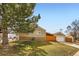 Side view of charming home with a well-kept lawn and detached garage at 1801 S Meade St, Denver, CO 80219