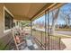 Relaxing front porch with rocking chairs, outdoor rug and decorative metal railings, perfect for enjoying the neighborhood view at 1801 S Meade St, Denver, CO 80219