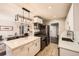 Modern kitchen with stainless steel appliances and an island with quartz countertops at 1801 S Meade St, Denver, CO 80219