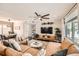 Bright and airy living room with a large leather couch, accent chairs, and view of adjacent dining area at 1801 S Meade St, Denver, CO 80219