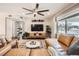 Stylish living room featuring a large leather sectional, modern ceiling fan, and ample natural light at 1801 S Meade St, Denver, CO 80219