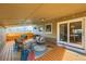 Relaxing covered patio featuring wicker seating, string lights, and sliding glass doors to the dining area at 1801 S Meade St, Denver, CO 80219