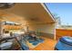 Spacious covered deck with outdoor seating, grill, and cozy ambiance for entertaining guests at 1801 S Meade St, Denver, CO 80219