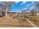Spacious backyard with mature trees, greenhouse, and plenty of room for outdoor activities at 1177 Jamaica St, Aurora, CO 80010