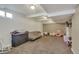 Spacious basement area with neutral carpet and lighting fixtures at 1177 Jamaica St, Aurora, CO 80010