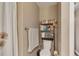 Compact bathroom with neutral tones features a shower and built-in shelving at 1177 Jamaica St, Aurora, CO 80010