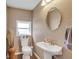 Small, well-lit bathroom features a pedestal sink and decorative accents at 1177 Jamaica St, Aurora, CO 80010