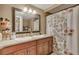 Bathroom with granite countertop, double sinks, large mirror, and shower at 1177 Jamaica St, Aurora, CO 80010