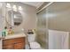 Cozy bathroom with a rounded mirror, walk-in shower, and neutral wall color at 1177 Jamaica St, Aurora, CO 80010