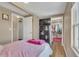 Cozy bedroom features wood-look floors, closet, and television at 1177 Jamaica St, Aurora, CO 80010