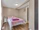 Inviting bedroom with soft pink accents, plush blanket and white walls at 1177 Jamaica St, Aurora, CO 80010