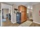 Hallway with laminate flooring, built-in storage, and neutral wall color at 1177 Jamaica St, Aurora, CO 80010