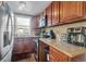 Well-equipped kitchen with wooden cabinets, granite countertops, and stainless steel appliances at 1177 Jamaica St, Aurora, CO 80010